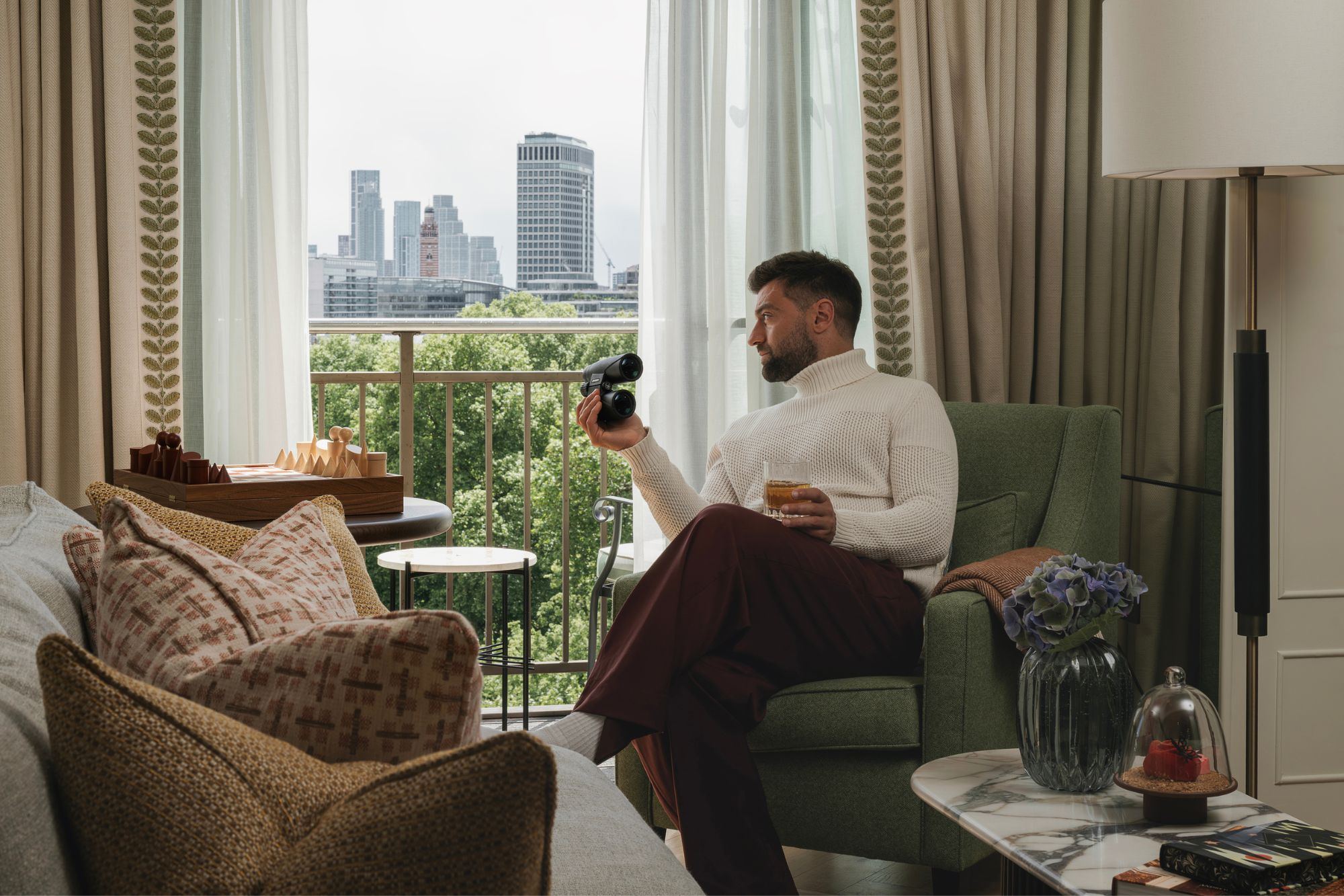 A guest looking out over Green Park from a Green Park View room