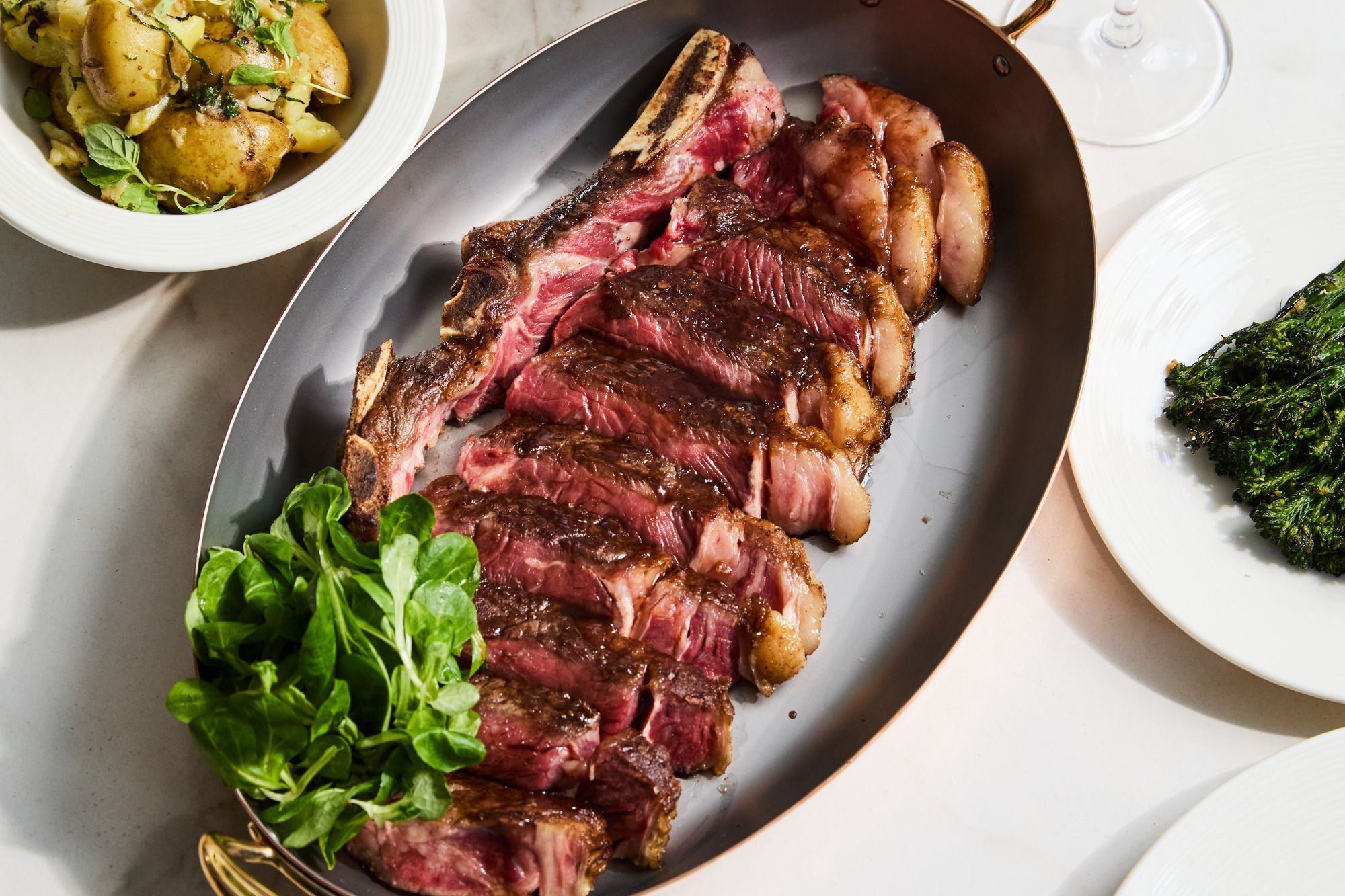 A sharing sirloin being carved at the table