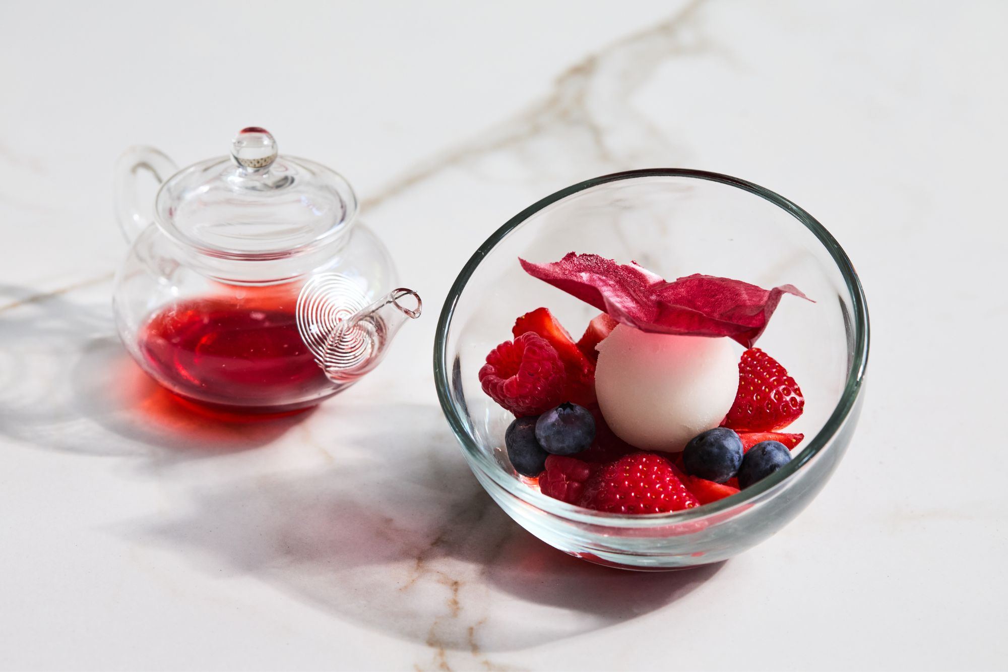 A berry dessert plated with cream
